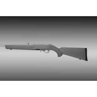 Side view of a bolt-action rifle with a long barrel and straight stock against a gray gradient background.