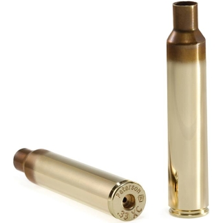 Two brass empty firearm cartridge casings, one upright and one lying on its side with headstamp visible (Peterson).