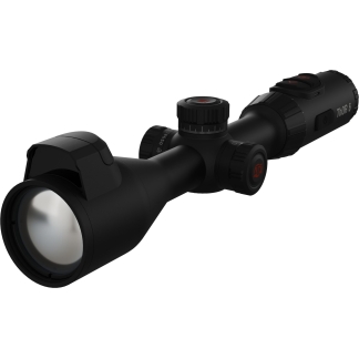 Close-up of a black riflescope with adjustable turrets and a large objective lens, showing a red logo on the adjustment dial.