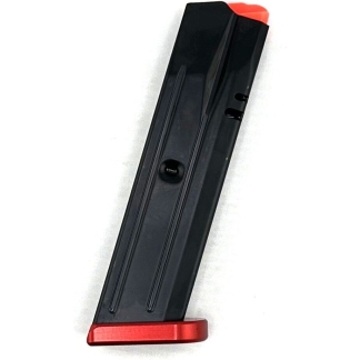 Black pistol magazine with a red base plate and orange follower lying on its side