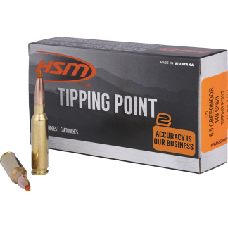 Box of HSM Tipping Point ammunition with two brass cartridges and copper tip; text reads 'TIPPING POINT', 'ACCURACY IS OUR BUSINESS' and 'MADE IN MONTANA' on dark gray packaging