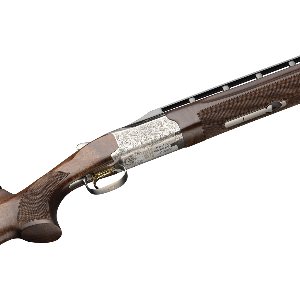 1211375_3 | ATFirearms Side view of an ornate hunting shotgun with a carved silver engraved receiver, rich wooden stock, and brass trigger guard.