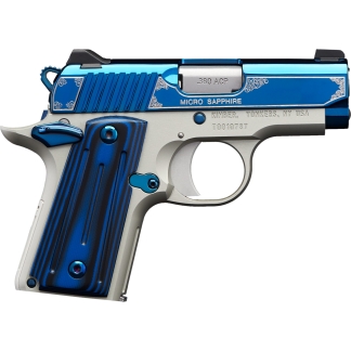 Close-up of a blue and silver handgun with ornate silver engravings on the slide and grip area.