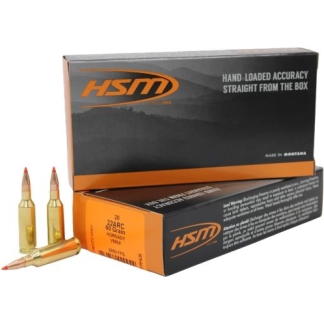 Two HSM ammunition boxes with orange-and-black branding, and several brass rifle cartridges laid out beside them.
