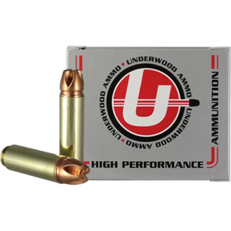 Box of Underwood High Performance ammunition with two copper-jacketed bullets leaning against it on a gray box surface.