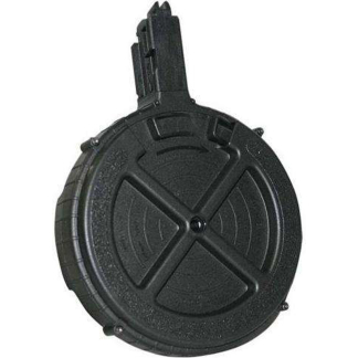 Close-up of a black circular, textured device with a vertical rectangular projection at the top.