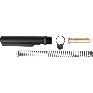 Disassembled firearm suppressor parts: black cylinder, long metal spring, circular mounting piece, and beige end cap.