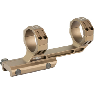 Gold-colored two-piece rifle scope rings mounted on a base to hold a telescopic sight.