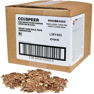 Cardboard box labeled brass-cased bulk-pack ammunition with loose brass cartridges scattered in front.