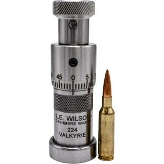 Reloading die with a micrometer dial beside a .224 Valkyrie cartridge and copper bullet tip