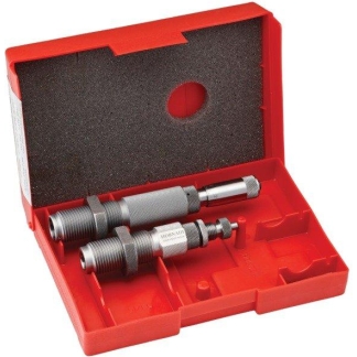 Red plastic case open to reveal two knurled metal dies used for ammunition reloading inside a compartmented tray