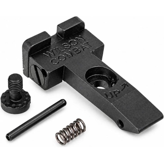 Black firearm accessory part with a screw, spring, and pin laid out beside it; labeled Wilson Combat (likely a trigger or hammer component).