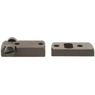Two small dark metal blocks with holes: the left block has a round adjustment knob and a slit, the right block shows a rectangular recessed pocket and two drilled holes.