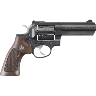 Engraved revolver with a wooden grip and intricate scrollwork on the metal, isolated on white.