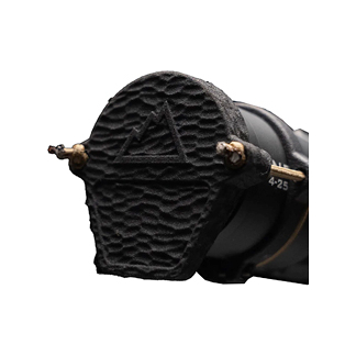 Close-up of a textured black power tool attachment end with a triangular logo and brass fittings on the sides.