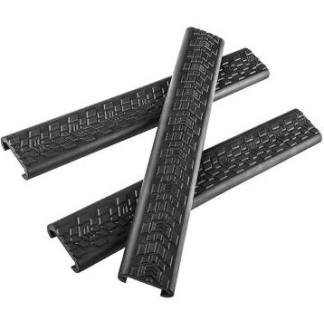 Four black plastic cable raceways/cord organizers for wire management, arranged in a scattered pile.