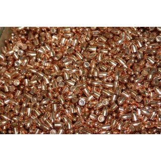 Close-up of a large pile of copper-colored spent cartridge casings scattered on a surface.