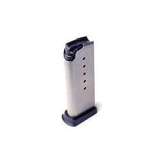 Metal pistol magazine standing upright with black top and base plates.