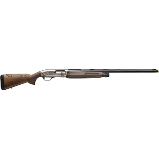 Side view of a classic break-action shotgun with a decorative engraved receiver, wooden stock and fore-end, and a long iron barrel.